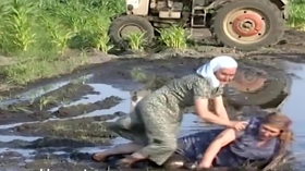 Grandmas wrestle in the mud